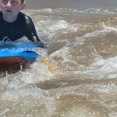a person riding a wave on a surfboard in the water