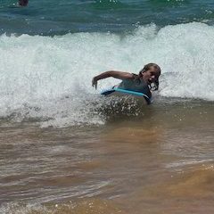 a girl riding a wave on a surfboard in the water