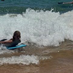 a person riding a wave on a surfboard in the water