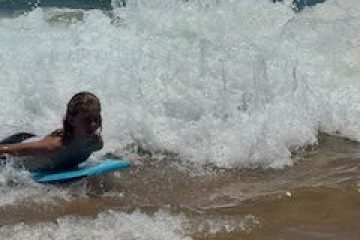 a person riding a wave on a surfboard in the water