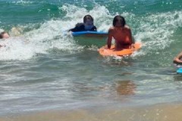 a group of people surfing in the ocean
