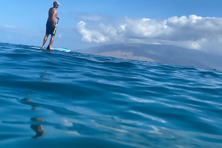 a person riding a wave on top of a body of water