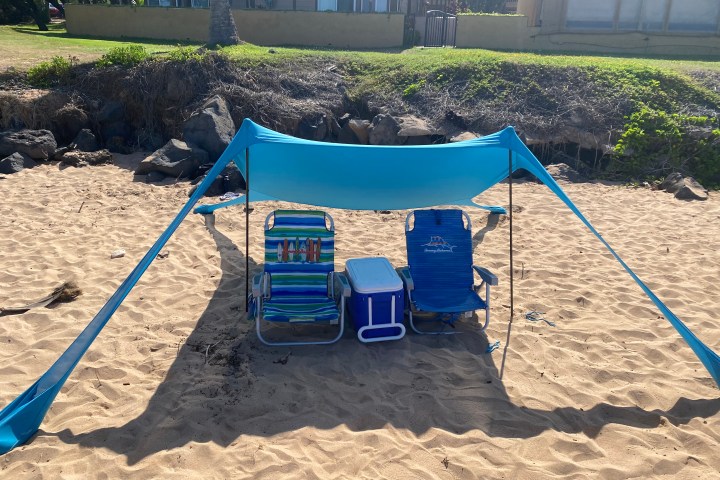 a person sitting on top of a sandy beach