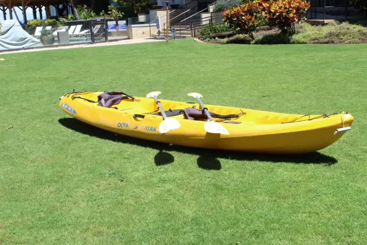a boat sitting on top of a grass covered field